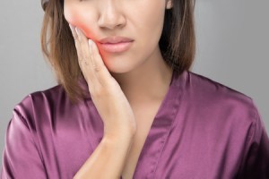 A woman feeling pain in her jaw